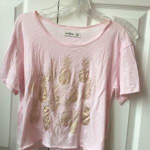 Light pink shirt with gold pineapples on it
